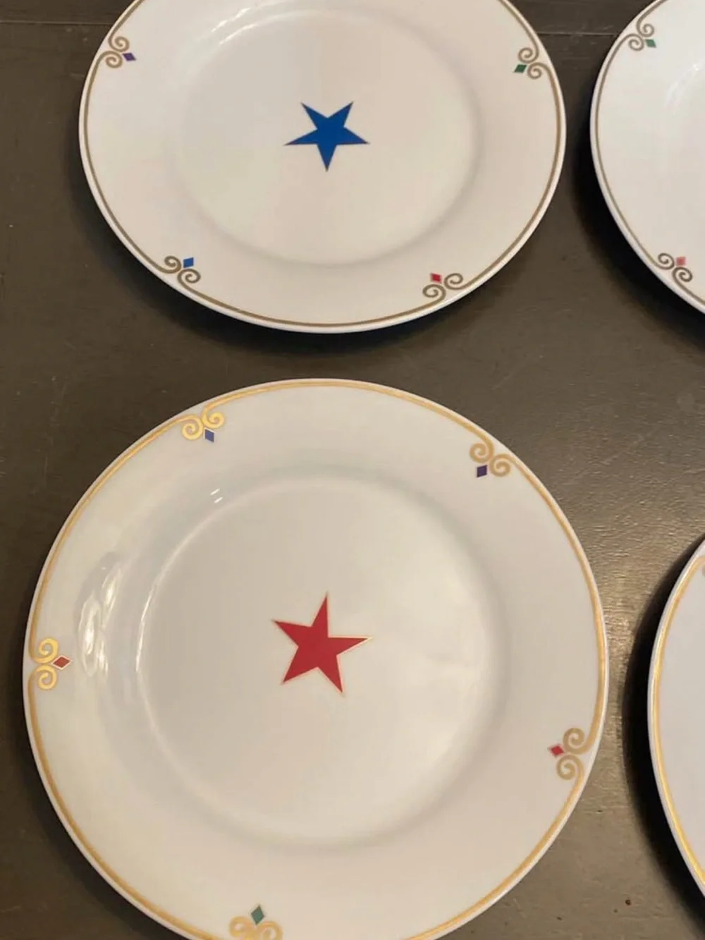 Pier 1 White  Plates with Multicolor Star Accents and Gold Trim